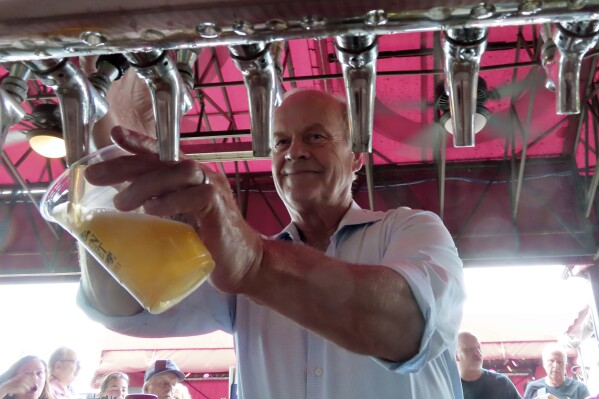 Actor Kelsey Grammer pours beers during a guest bartending stint at the Golden Nugget casino in Atlantic City, N.J. on July 14, 2023. Atlantic City's casinos won 3% less from in-person gamblers in July as they did a year earlier, although total gambling revenue, including internet and sports betting at casinos and horse tracks, rose by 5.3%. (AP Photo/Wayne Parry)
