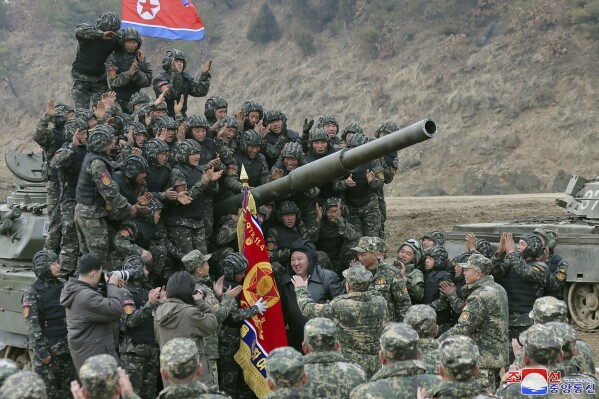 FILE - In this photo provided by the North Korean government, North Korean leader Kim Jong Un, center, meets soldiers who took part in a training in North Korea, on March 13, 2024. Independent journalists were not given access to cover the event depicted in this image distributed by the North Korean government. The content of this image is as provided and cannot be independently verified. Korean language watermark on image as provided by source reads: "KCNA" which is the abbreviation for Korean Central News Agency. (Korean Central News Agency/Korea News Service via AP, File)
