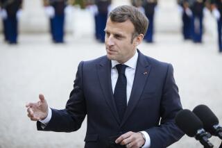 French President Emmanuel Macron gestures while addressing the media prior to a working lunch with Slovenian Prime Minister Janez Jansa at the Elysee palace in Paris, Thursday April 29, 2021. President Emmanuel Macron said Thursday that the outdoor terraces of France's cafes and restaurants will be allowed to reopen on May 19 along with museums, cinemas, theaters and concert halls under certain conditions. (AP Photo/Lewis Joly)