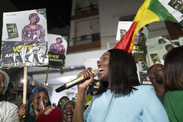 Presidential candidate Anta Babacar Ngom greets supporters during her electoral campaign caravan in Dakar, Senegal, Monday, March 11, 2024. Senegal’s only female presidential candidate may stand no chance of winning but activists say her presence alone is helping to advance a decades long campaign to achieve equality in the West African nation. (AP Photo/Sylvain Cherkaoui)