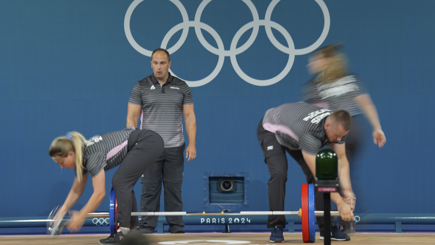 Like pit crews, but in weightlifting. How loaders keep Olympic sports going