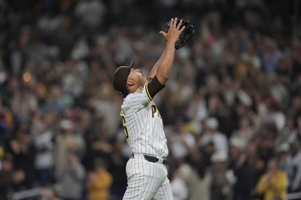 San Diego Padres relief pitcher Jeremiah Estrada celebrates after the Padres defeated the Miami Marlins 4-0 in a baseball game Tuesday, May 28, 2024, in San Diego. Estrada extended his club-record strikeout streak to 13 batters, the most in the expansion era. (AP Photo/Gregory Bull)