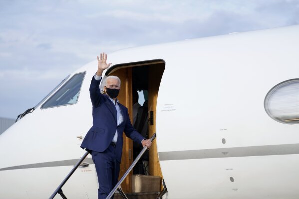 Democratic presidential candidate former Vice President Joe Biden waves as he boards a plane at Charlotte Douglas International Airport in Charlotte, N.C., Wednesday, Sept. 23, 2020, en route to Wilmington, De. (AP Photo/Carolyn Kaster)