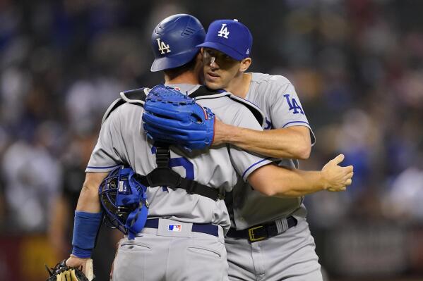 Los Angeles Dodgers starting pitcher Walker Buehler, right, celebrates his three-hit complete game with catcher Will Smith after a baseball game against the Arizona Diamondbacks, Monday, April 25, 2022, in Phoenix. The Dodgers defeated the Diamondbacks 4-0. (AP Photo/Matt York)