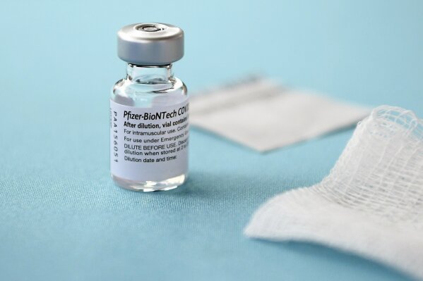 FILE - In this Monday, Dec. 14, 2020, file photo, a vial of the Pfizer-BioNTech vaccine for COVID-19 sits on a table at Hartford Hospital in Hartford, Conn. New research suggests that Pfizer’s COVID-19 vaccine can protect against a mutation found in two contagious variants of the coronavirus that erupted in Britain and South Africa. Those variants are causing global concern. They both share a common mutation called N501Y, a slight alteration on one spot of the spike protein that coats the virus. That change is believed to be the reason they can spread so easily. (AP Photo/Jessica Hill, File)