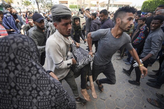 Palestinos llevan a una persona herida en un ataque israelí cerca del hospital de Al Aqsa en Deir al Balah, en a Franja de Gaza, el domingo 31 de marzo de 2024. (AP Foto/Abdel Kareem Hana)