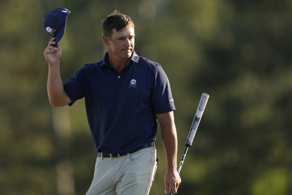 Bryson DeChambeau waves after finishing his final round at the Masters golf tournament at Augusta National Golf Club Sunday, April 14, 2024, in Augusta, Ga. (AP Photo/David J. Phillip)