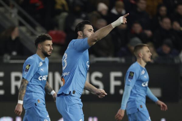 Marseille's Sead Kolasinac, center, celebrates after scoring the opening goal during the French League One soccer match between Rennes and Olympique Marseille, at the Roazhon Park stadium in Rennes, France, Sunday, March 5, 2023. (AP Photo/Jeremias Gonzalez)