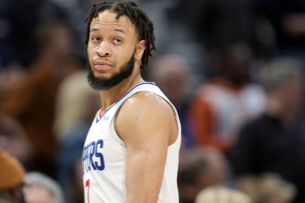 FILE - Los Angeles Clippers guard Amir Coffey looks on during overtime of an NBA basketball game Feb. 26, 2023, in Denver. Coffey was arrested early Sunday, July 30, 2023, on a firearms misdemeanor in Hollywood, authorities said. (AP Photo/David Zalubowski, File)