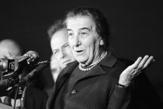Israeli Premier Golda Meir gestures to newsmen September 16, 1970 at New York's Kennedy Airport on her arrival from Tel Aviv. She flew to the U.S. aboard an El Al Jetliner for talks with president Nixon, Secretary of State William P. Rogers and other top U.S. officials on the middle east situation.(AP Photo/Ron Frehm)
