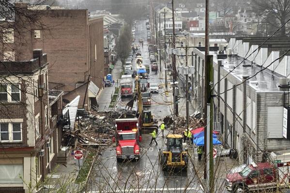 Emergency responders and heavy equipment are seen at the site of a deadly explosion at a chocolate factory in West Reading, Pennsylvania, Saturday, March 25. (AP Photo/Michael Rubinkam)