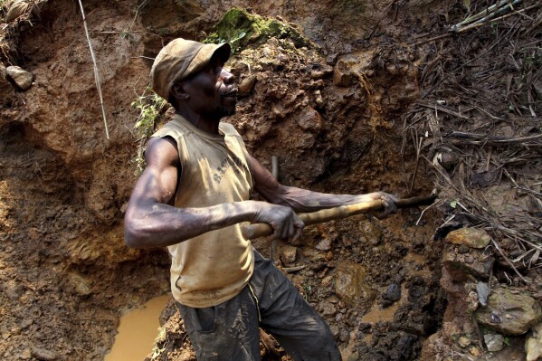 FILE - One of the few remaining miners digs out soil which will later be filtered for traces of cassiterite, the major ore of tin, at Nyabibwe mine, in eastern Congo, on Aug. 17, 2012. The governor of the South Kivu province in eastern Congo on Friday ordered the suspension of all mining activities in order to “restore order” in the mineral-rich region plagued by violence from armed groups. (ĢӰԺ Photo/Marc Hofer, File)