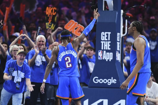 Oklahoma City Thunder's Shai Gilgeous-Alexander (2) and Jalen Williams, right, celebrate as fans cheer late in the second half of Game 7 in the Western Conference semifinals of the NBA basketball playoffs against the Denver Nuggets, Sunday, May 18, 2025, in Oklahoma City. (AP Photo/Kyle Phillips)