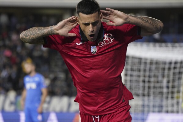 Atalanta's Gianluca Scamacca celebrates after scoring his side's opening goal during the Serie A soccer match between Empoli and Atalanta at the Castellani stadium in Empoli, Italy, Monday, Oct. 30, 2023. (Marco Bucco/LaPresse via AP)