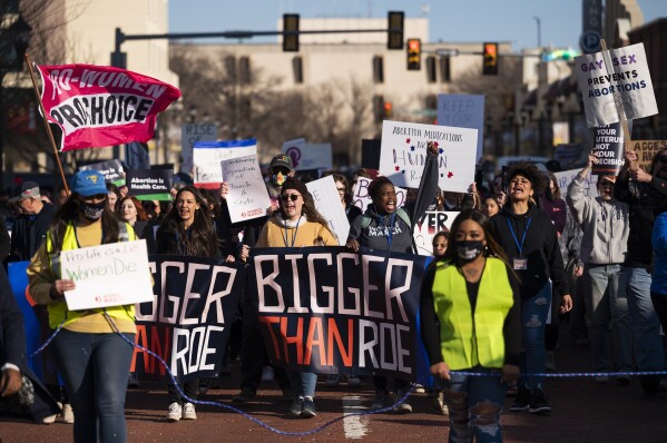 FILE - People march through downtown Amarillo to protest a lawsuit to ban the abortion drug mifepristone, Feb. 11, 2023, in Amarillo, Texas. Two years after the U.S. Supreme Court ended a nationwide right to abortion, travel and pills have become big parts of the issue.(AP Photo/Justin Rex, File)