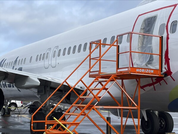This image taken Sunday, Jan. 7, 2024, and released by the National Transportation Safety Board, shows a section of Alaska Airlines Flight 1282 that is missing panel on a Boeing 737-9 MAX in Portland, Ore. Federal officials are investigating Boeing's oversight of production of a panel that blew off a jetliner in midflight last week. (NTSB via AP)