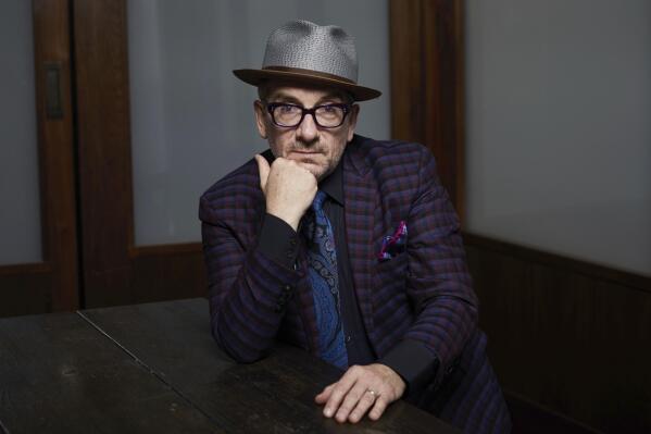 FILE - Elvis Costello poses for a portrait at The Redbury New York hotel in New York on Sept. 17, 2018. Costello's new album, the coronavirus-era disc "The Boy Named If" was made in solitary style — four musicians, five if you count a backup singer on one song — all worked from their own homes. He says that conjures the image of a laid-back sound, but the new disc is an up-tempo, guitar-based selection of crankin' rock songs. 
 (Photo by Matt Licari/Invision/AP, File)