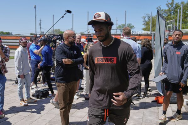 Cleveland Browns quarterback Shedeur Sanders (12) leaves a news conference during the NFL football team's rookie minicamp in Berea, Ohio, Saturday, May 10, 2025. (AP Photo/Sue Ogrocki)