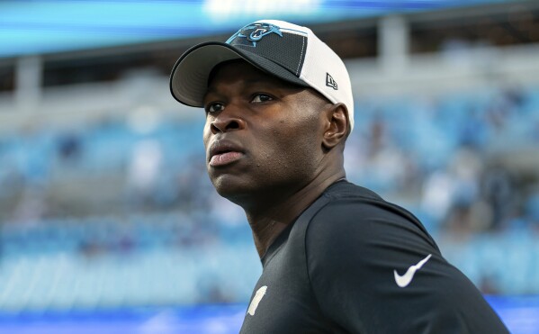 FILE - Carolina Panthers defensive coordinator Ejiro Evero looks on before an NFL football game against the New Orleans Saints Monday, Sept. 18, 2023, in Charlotte, N.C. Evero met again with the Atlanta Falcons to discuss their head coaching vacancy, Wednesday, Jan. 24, 2024, joining Rams assistant Raheem Morris and former Patriots coach Bill Belichick in receiving second interviews.(AP Photo/Jacob Kupferman, File)