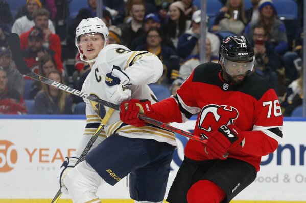 Buffalo Sabres forward Jack Eichel (9) and New Jersey Devils defenseman P.K. Subbam (76) collide during the third period of an NHL hockey game Monday, Dec. 2, 2019, in Buffalo, N.Y. (AP Photo/Jeffrey T. Barnes)