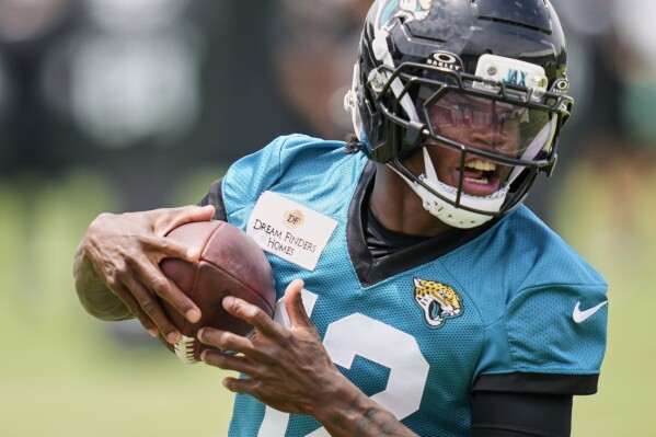 Jacksonville Jaguars wide receiver Travis Hunter makes a reception during the NFL football team's rookie minicamp, Saturday, May 10, 2025, in Jacksonville, Fla. (AP Photo/John Raoux)