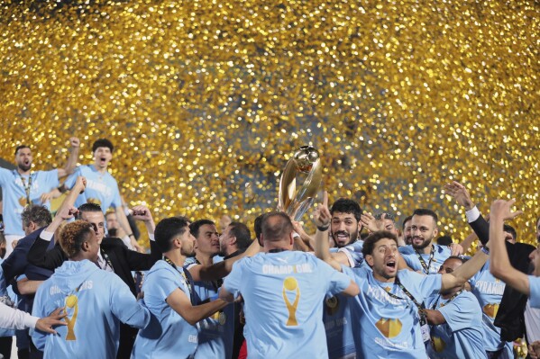Pyramids players celebrate with the trophy after winning the CAF Champions League final second leg soccer match against Mamelodi Sundowns at the Air Defense Stadium in Cairo, Egypt, Sunday, June 1, 2025. (AP Photo)