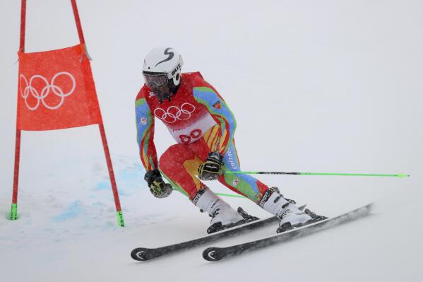 Shannon Abeda, of Eritrea passes a gate during the first run of the men's giant slalom at the 2022 Winter Olympics, Sunday, Feb. 13, 2022, in the Yanqing district of Beijing. (AP Photo/Alessandro Trovati)