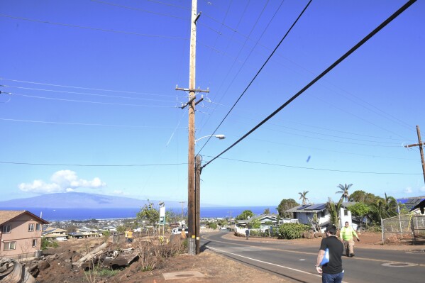 This photo provided by the Morgan & Morgan law firm shows a Hawaiian Electric pole on Lahainialuna Road where downed power lines sparked an initial fire shortly after dawn on Aug. 8., 2023, in Lahaina, Maui, Hawaii, seen on Aug. 29, 2023. Investigators are examining pieces of evidence as they seek to solve the mystery of how a small, wind-whipped fire sparked by downed power lines and declared extinguished flare up again hours later into a devastating inferno. (Morgan & Morgan via AP)