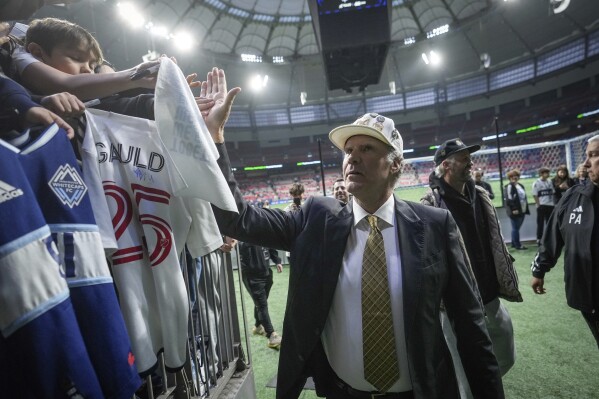 Los Angeles FC co-owner, comedian and actor Will Ferrell, center, greets Vancouver Whitecaps fans as he leaves the field before Game 2 of a first-round MLS playoff soccer match in Vancouver, British Columbia, Sunday, Nov. 5, 2023. (Darryl Dyck/The Canadian Press via AP)