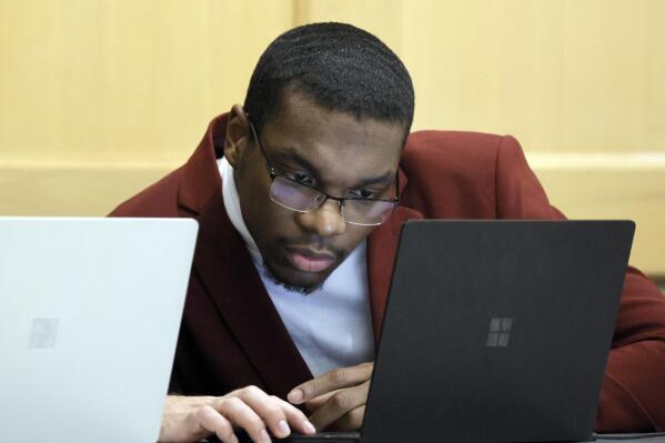 Shooting suspect Michael Boatwright looks at his attorney's computer at the defense table on the fourth day of jury deliberations in the XXXTentacion murder trial at the Broward County Courthouse in Fort Lauderdale, Fla., Monday, March 13, 2023. Emerging rapper XXXTentacion, born Jahseh Onfroy, 20, was killed during a robbery outside of Riva Motorsports in Pompano Beach in 2018, allegedly by defendants Boatwright, Trayvon Newsome, and Dedrick Williams. (Amy Beth Bennett/South Florida Sun-Sentinel via AP, Pool)