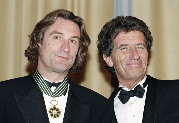 American actor Robert De Niro, left, appears with French Minister of Culture, Jack Lang, after receiving the French Medal of Art and Letters during the 44th Cannes Film Festival in Southern France on May 17, 1991. (AP Photo/Jose Goitia, File)