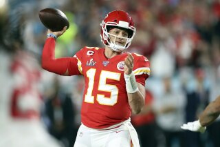 FILE- In this Feb. 2, 2020, file photo, Kansas City Chiefs quarterback Patrick Mahomes (15) throws a pass during Super Bowl 54 against the San Francisco 49ers in Miami Gardens, Fla. The Super Bowl MVP is joining the ownership group of the Kansas City Royals.(AP Photo/Doug Benc, File)