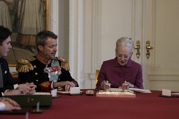 Denmark's Queen Margrethe II signs a declaration of abdication in the Council of State at Christiansborg Castle in Copenhagen, Sunday, Jan. 14, 2024. Queen Margrethe II has signed her historic abdication. It's a step that paves the way for her son Frederik X to immediately become king. (Mads Claus Rasmussen/Ritzau Scanpix via AP)