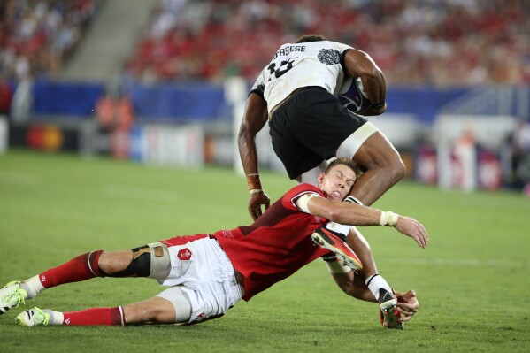 Fiji's Ilaisa Droasese evades a tackle by Wales' Liam Williams during the Rugby World Cup Pool C match between Wales and Fiji at the Stade de Bordeaux in Bordeaux, France, Sunday, Sept. 10, 2023. (AP Photo/Bob Edme)