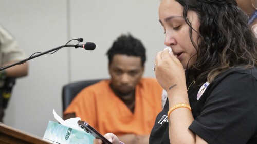 D’Pree Shareef Robinson listens as stepmother Korrina Smith reads letters from Trinity Ottoson-Smith's friends about what her loss means to them Tuesday, July 11, 2023, in Minneapolis. Robinson was sentenced Tuesday to more than 37 years in prison for fatally shooting a 9-year-old Minnesota girl as she was jumping on a trampoline with friends. Robinson pleaded guilty in March to second-degree murder in the 2021 death of Ottoson-Smith. (Glen Stubbe/Star Tribune via AP, Pool)