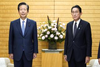 Japanese Prime Minister Fumio Kishida, right, and the leader of Kishida's coalition partner, Natsuo Yamaguchi pose for a photo as they meet to discuss a bill to help victims of the religious group known as the Unification Church, at the prime minister's official residence in Tokyo, Tuesday, Nov. 8, 2022. (Keisuke Hosojima/Kyodo News via AP)