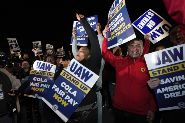 Striking United Auto Workers picket at Ford's Michigan Assembly Plant in Wayne, Mich., shortly after midnight Friday, Sept. 15, 2023. (AP Photo/Paul Sancya)