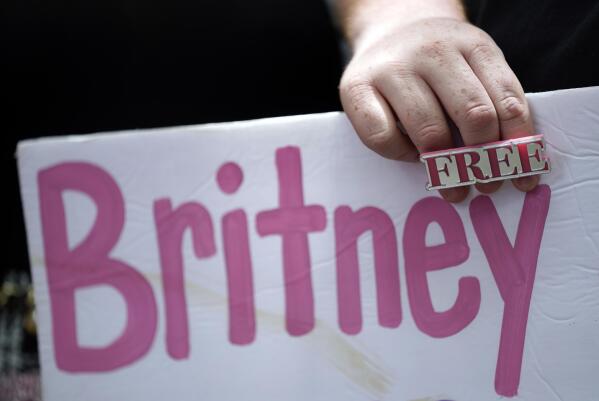 A Britney Spears supporter holds a sign outside a court hearing concerning the pop singer's conservatorship at the Stanley Mosk Courthouse, Wednesday, June 23, 2021, in Los Angeles. (AP Photo/Chris Pizzello)