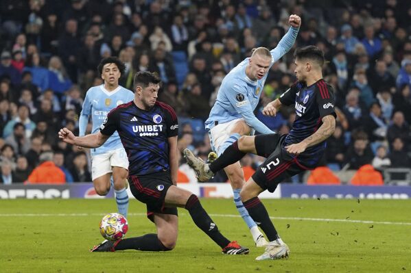 Manchester City's Erling Haaland, second from right, scores his side's third goal during a Champions League round of sixteen second leg soccer match between Manchester City and Copenhagen, at the Etihad Stadium in Manchester, England, Wednesday, March 6, 2024. (Nick Potts/PA via AP)