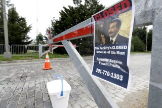 
              A sign hangs from a barricade at the entrance to Liberty State Park, which remains closed due to the New Jersey government shutdown, Saturday, July 1, 2017, in Jersey City., N.J. Gov. Chris Christie and the Democrat-led Legislature are set to return to work to try to resolve the state's first government shutdown since 2006 and the first under Christie. The Republican governor and the Democrat-led Legislature failed to reach an agreement on a new budget by the deadline at midnight Friday. Christie ordered nonessential services, including state parks and the motor vehicle commission to close beginning Saturday. Remaining open under the shutdown will be New Jersey Transit, state prisons, the state police, state hospitals and treatment centers as well as casinos, race tracks and the lottery. (AP Photo/Julio Cortez)
            