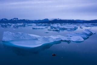FILE - A boat navigates at night next to large icebergs near the town of Kulusuk, in eastern Greenland on Aug. 15, 2019. A new massive study finds that Greenland and Antarctic ice sheets are now losing more than three times as much ice a year as they were 30 years ago. (AP Photo/Felipe Dana, File)