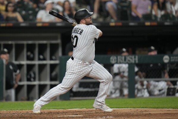 Chicago White Sox's Jake Burger watches his home run against the Cleveland Guardians during the fifth inning of a baseball game Thursday, July 27, 2023, in Chicago. (AP Photo/Erin Hooley)