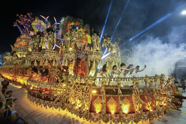Dancers from the Dragoes da Real samba school perform on a float during a carnival parade in Sao Paulo early Saturday, Feb. 10, 2024. (AP Photo/Andre Penner)