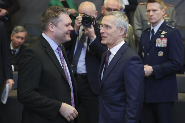 Finland's Defense Minister Antti Kaikkonen, left, talks to NATO Secretary General Jens Stoltenberg during the North Atlantic Council round table meeting of NATO defense ministers at NATO headquarters in Brussels, Wednesday, Feb. 15, 2023. (AP Photo/Olivier Matthys)