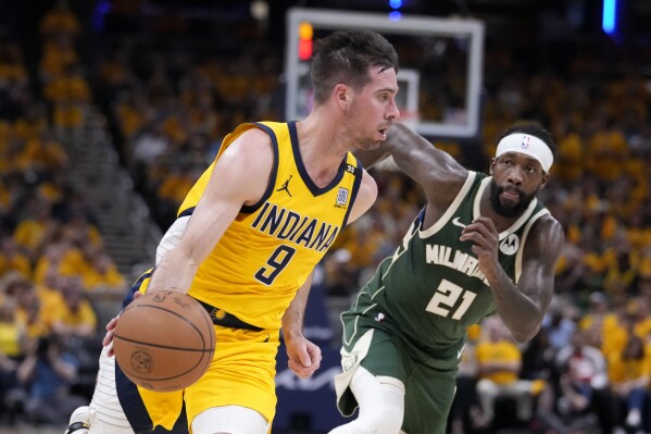 Indiana Pacers guard T.J. McConnell (9) drives past Milwaukee Bucks guard Patrick Beverley (21) during the first half in Game 6 in an NBA basketball first-round playoff series, Thursday, May 2, 2024, in Indianapolis. (AP Photo/Michael Conroy)
