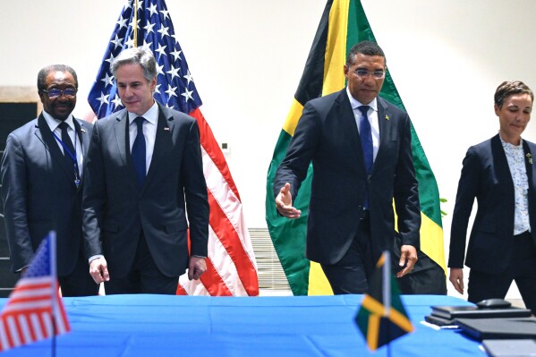 Secretary of State Antony Blinken, poses for a photo with Jamaica's Foreign Minister Kamina Johnson Smith, right, Jamaica's Prime Minister Andrew Holness and U.S. Ambassador to Jamaica N. Nick Perry, left, during a meeting on Haiti at the Conference of Heads of Government of the Caribbean Community (CARICOM) in Kingston, Jamaica, on Monday, March 11, 2024. (Andrew Caballero-Reynolds, Pool via AP)