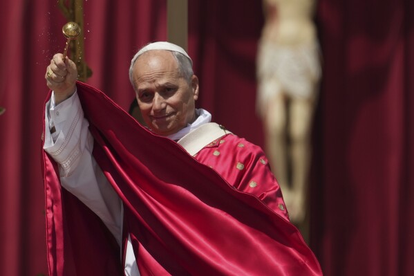 Pope Leo XIV spreads holy water as he celebrates a Mass for the Jubilee of New Religious Associations on Pentecost Day in St. Peter's Square at the Vatican, Sunday, June 8, 2025. (AP Photo/Andrew Medichini, File)