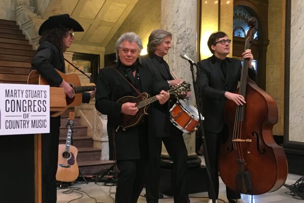 
              Country singer Marty Stuart, second from left, performs at the Mississippi Capitol with members of his band, The Fabulous Superlatives, on Wednesday, Jan. 31, 2018. Band members are Kenny Vaughan, left, Harry Stinson, second from right, and Chris Scruggs. Stuart says he is planning to develop a museum called Marty Stuart's Congress of Country Music in his hometown of Philadelphia, Miss. ( AP Photo/Emily Wagster Pettus)
            