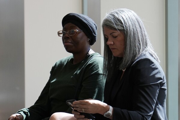 Sheneen McClain, mother of Elijah McClain, sits with Colorado Solicitor General Shannon Stevenson outside the courtroom at the Adams County Justice Center for the start of a trial of two of the police officers charged in the death of her son, Wednesday, Sept. 20, 2023, in Brighton, Colo. (AP Photo/Jack Dempsey).