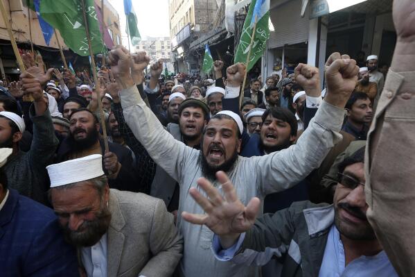 Supporters of Jamaat-e-Islami chant slogans during a protest against the burning of Quran, a Muslim holy book, by a Danish anti-islam activist, in Peshawar, Pakistan, Friday, Jan. 27, 2023. (AP Photo/Muhammad Sajjad)